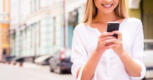 smiling woman looking at phone