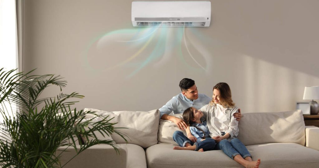 family sitting beneath ductless air conditioning